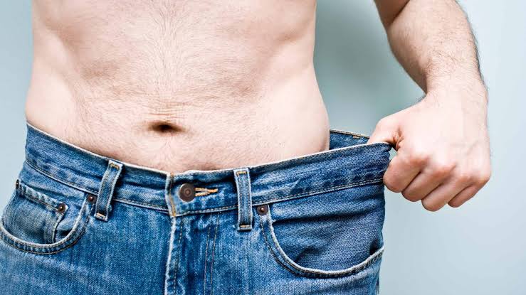 Looser-fitting jeans illustrating gradual progress toward personal goals